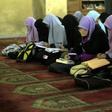 Students read during an Islamic course at Al-Azhar mosque in the old city of Cairo on December 4, 2011
