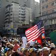 A US flag is seen amid the crowd of supporters of Venezuelan opposition leader Juan Guaido, as people start gathering for a rally to press the military to let in US humanitarian aid, in Caracas on February 12, 2019