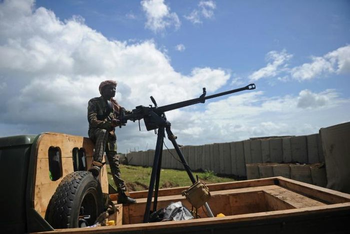 A Somali soldier with a vehicle-mounted heavy machine gun keeps an eye out for danger at the Sanguuni military base south of the capital Mogadishu