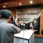 Journalists in Tehran photograph and film a poster calling for the release of Marzieh Hashemi, a US-born presenter for Iran's Press TV who was arrested on a visit to her birth country