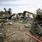 Firefighters and security forces gather at the crash site of a Boeing 707 cargo plane that slammed into a residential complex near the Iranian capital Tehran with at least 10 people onboard on January 14, 2019