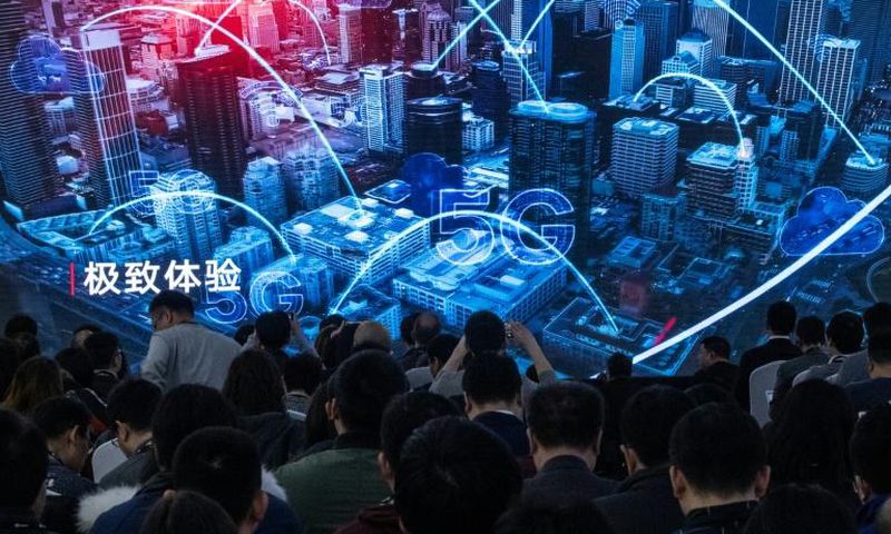 Journalists watch a trailer at the launch of new 5G Huawei products in Beijing in January