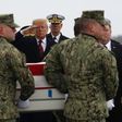 President Donald Trump salutes as the remains of one of four Americans killed in Manbij is returned to the US