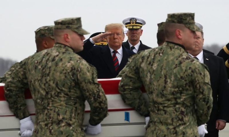 President Donald Trump salutes as the remains of one of four Americans killed in Manbij is returned to the US