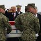 President Donald Trump salutes as the remains of one of four Americans killed in Manbij is returned to the US