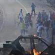 Venezuelans protest near the Cotiza National Guard headquarters in Caracas, where a group of soldiers were arrested on Monday after rising up against President Nicolas Maduro