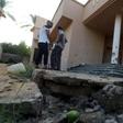 Libyans examine the site where a mortar shell landed in Tripoli during a previous round of deadly clashes between militias on August 30, 2018