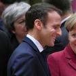 France's President Emmanuel Macron (L) talks with Germany's Chancellor Angela Merkel want to strengthen ties betweeen their two countries