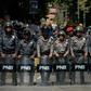 Venezuelan police stand guard near a hospital during a protest against the government of President Nicolas Maduro