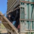 Children were among hundreds of people trucked out of the last patch of IS-held territory