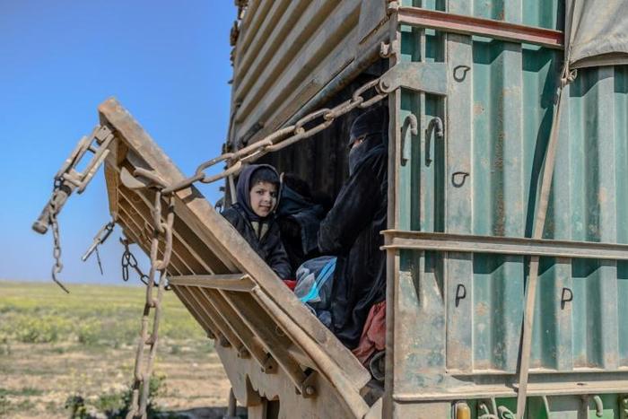 Children were among hundreds of people trucked out of the last patch of IS-held territory