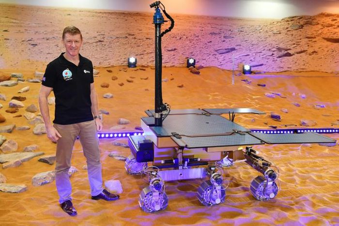 British astronaut Tim Peake poses with a working prototype of the Rosalind Franklin ExoMars Rover