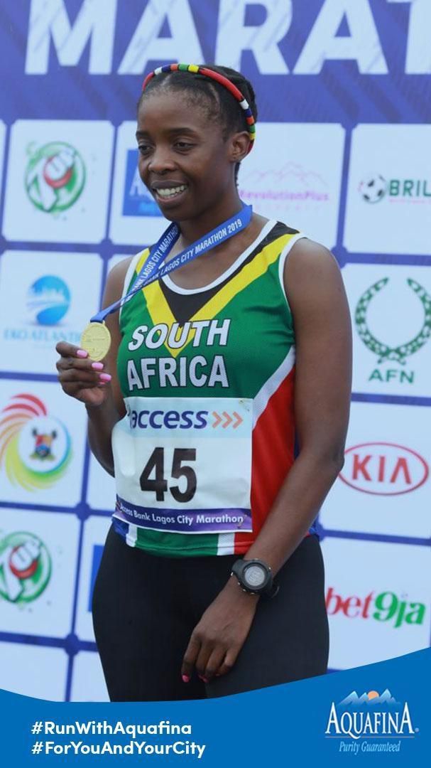 A runner wearing a participatory medal