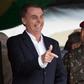 Brazil's President-elect Jair Bolsonaro (L), pictured at a graduation ceremony November 24, 2018, is embroiled in a crisis over campaign financing