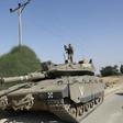 An Israeli soldier stands on a Merkava tank stationed on the Israeli border with the Gaza Strip, on November 13 2018