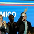 Venezuela's opposition leader and self-proclaimed "acting president" Juan Guaido (C) gives the thumbs-up as he prepares to present his "rescue plan" for the country