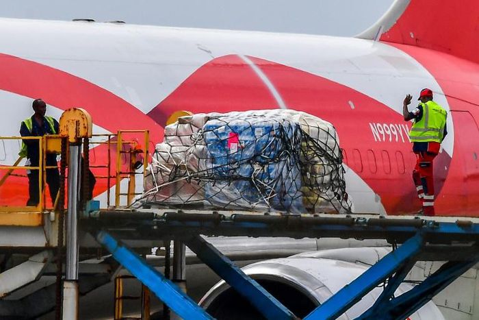 Workers unload food and medical aid from a Boeing 767 aircraft on Curacao, a sleepy island that has become the focus of a tense bid to bring aid by sea to Venezuela