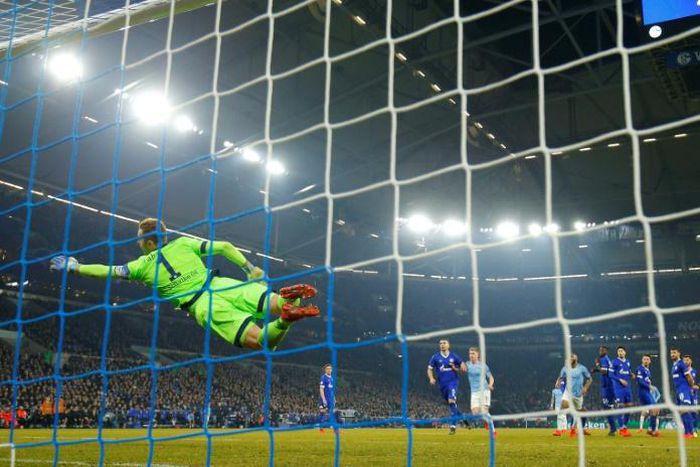 Schalke's German goalkeeper Ralf Faehrmann is beaten by Leroy Sane's stunning free-kick as Manchester City equalised before Raheem Sterling scored the late winner to seal a 3-2 victory in the Champions League, last 16, first leg match on Wednesday.