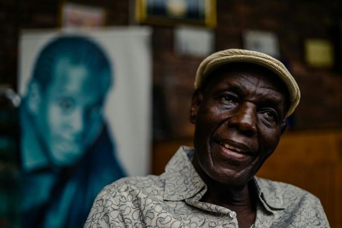 Zimbabwe music icon Oliver 'Tuku' Mtukudzi, pictured in January 2018. Over his shoulder is a portrait of his late son, Sam Mtukudzi
