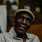 Zimbabwe music icon Oliver 'Tuku' Mtukudzi, pictured in January 2018. Over his shoulder is a portrait of his late son, Sam Mtukudzi