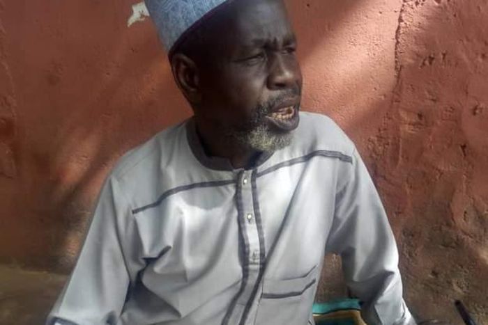 A Quran is positioned close to 61-year-old Abubakar Shettima, who sits on a praying mat to await the commencement of voting. He has visited a polling unit two days earlier than expected. [BBC News]