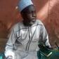 A Quran is positioned close to 61-year-old Abubakar Shettima, who sits on a praying mat to await the commencement of voting. He has visited a polling unit two days earlier than expected. [BBC News]
