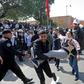 Moroccan public school teachers help a colleague who was injured in a scuffle with police during a demonstration in the capital Rabat on February 20, 2019