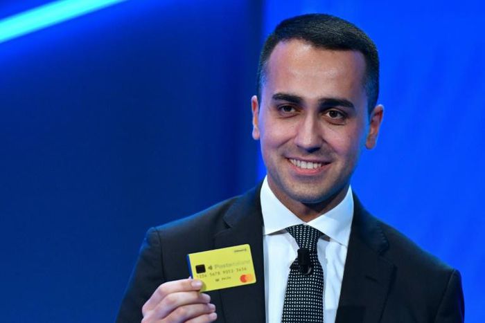 Italian Deputy Prime Minister and M5S leader Luigi Di Maio -- pictured Feburary 4, 2019, holding the first "Citizenship Wage" card, part of a plan to pay poorest Italians a basic monthly income -- said the IMF has "starved people for decades"