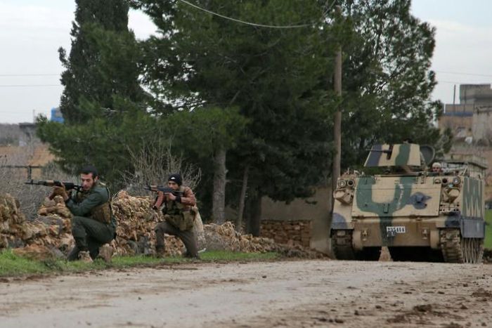 Turkish-backed Syrian rebels participate in a training exercise using an armoured vehicle provided by the Turkish army near Tal Hajar in Aleppo's province, a few kilometres from areas controlled by a Kurdish-led coalition