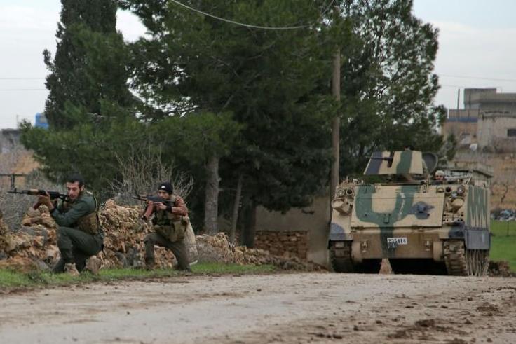 Turkish-backed Syrian rebels participate in a training exercise using an armoured vehicle provided by the Turkish army near Tal Hajar in Aleppo's province, a few kilometres from areas controlled by a Kurdish-led coalition