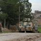 Turkish-backed Syrian rebels participate in a training exercise using an armoured vehicle provided by the Turkish army near Tal Hajar in Aleppo's province, a few kilometres from areas controlled by a Kurdish-led coalition