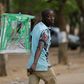 An election official walks away with an empty ballot box at the end of votes count