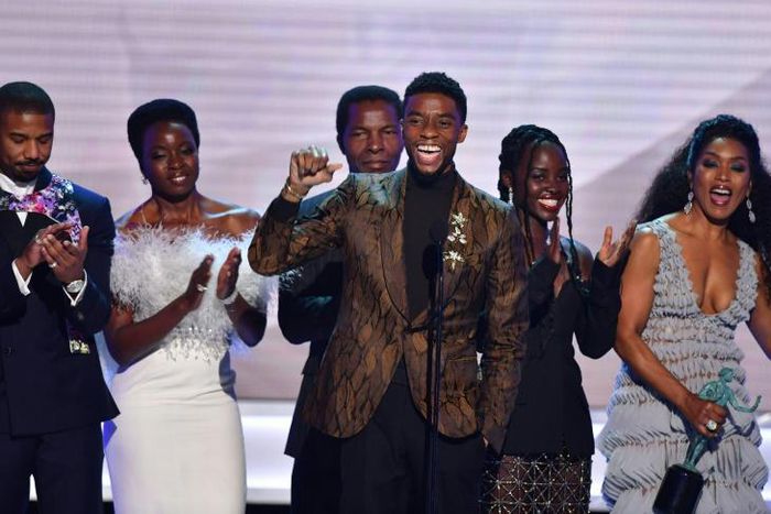 Chadwick Boseman (C) accepts the top SAG Award for "Black Panther" flanked by his castmates including Michael B. Jordan (L), Danai Gurira (C), Lupita Nyong'o (2R) and Angela Bassett (R)