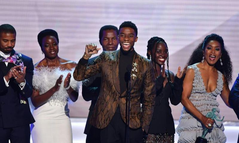 Chadwick Boseman (C) accepts the top SAG Award for "Black Panther" flanked by his castmates including Michael B. Jordan (L), Danai Gurira (C), Lupita Nyong'o (2R) and Angela Bassett (R)