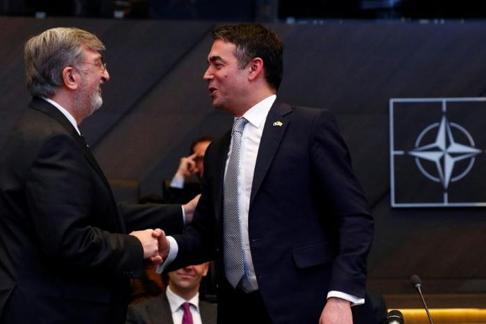 Greek NATO representative Spiros Lambridis (L) shakes hands with Macedonian Foreign Minister Nikola Dimitrov after the signature ceremony of the accession protocol between the Republic of North Macedonia and NATO on February 6, 2019