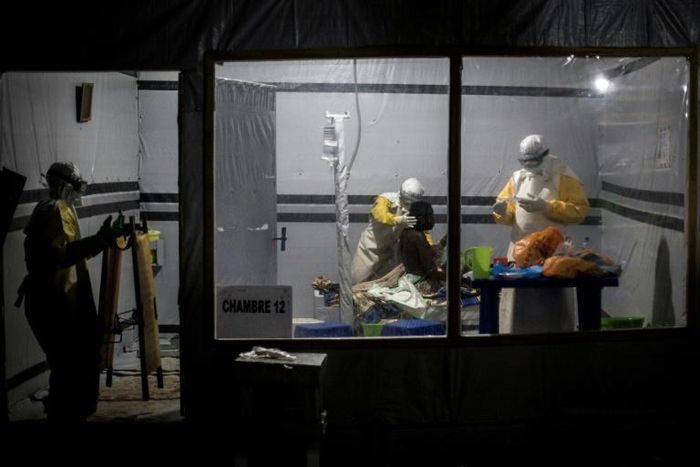 Health workers treat an unconfirmed Ebola patient inside a Doctors Without Borders-supported Ebola Treatment Center in east Democratic Republic of Congo, where the aid organization has suspended non-essential work after gunmen abducted two of its local...