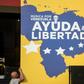 Workers set up posters for a charity concert for the Venezuelan opposition