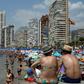 In the resort of Benidorm, pubs and English ads for mobility scooters for the elderly abound
