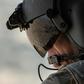 A partial view of the Iraqi capital is reflected in the visor of a US army helicopter crew member as he looks out of a Chinook helicopter over Baghdad on January 9, 2019