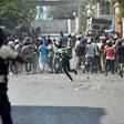 Demonstrators flee as Haitian Police open fire, during the clashes, in the centre of Haitian Capital Port-au-Prince