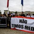 Striking nurses in Portugal, shown here holding a banner reading "We Are Not Afraid", want higher wages, more overtime pay and an end to a freeze on promotions