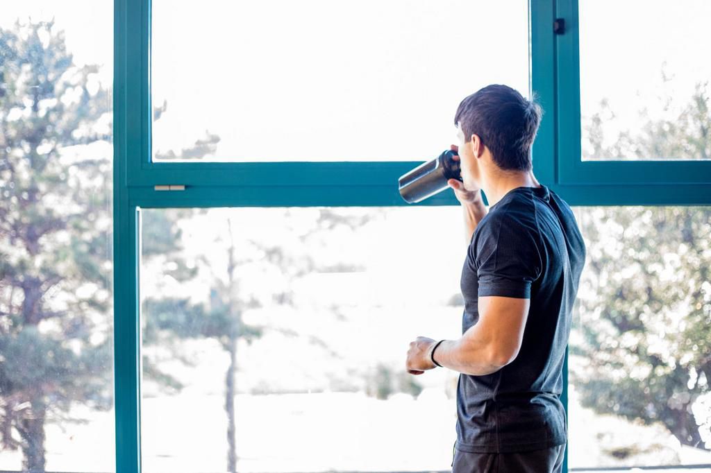 Young Man Drinking Protein Shake Indoors