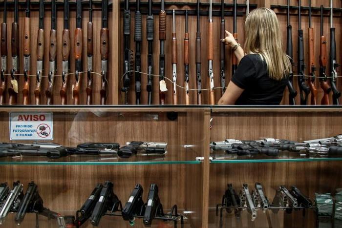At a gun shop in Sao Paulo, Brazilian President Jair Bolsonaro's rollback of restrictions on gun ownership was welcomed, but not everyone believes it can stem the country's spiral of violence