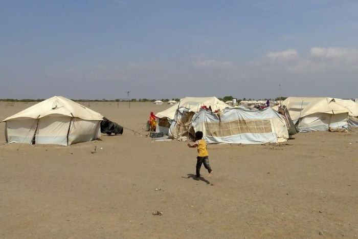 In this file photo, a Yemeni child runs toward a tent at a camp for displaced people in the Khokha district of Hodeida province on December 11, 2018