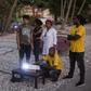 Setting up an outdoors projector to screen a movie near the beach in the Haitian port city of Jacmel, as part of the "Southern Lights" film festival
