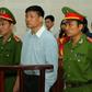 Blogger Truong Duy Nhat stands trial in the Vietnamese city of Danang in March 2014 after criticizing the communist leadership (C) stands trial at a local People's Court in the central city of Da Nang on March 4, 2014. Popular Vietnamese blogger and jo...