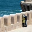 An Egyptian couple embracing during a stroll on Pharos Island in the port of Alexandria