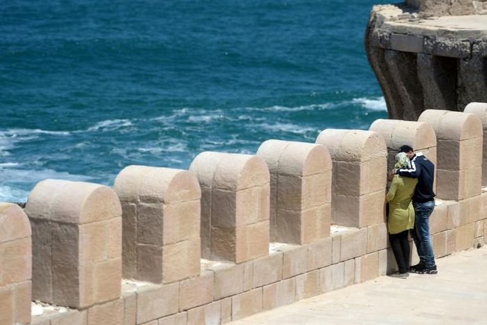 An Egyptian couple embracing during a stroll on Pharos Island in the port of Alexandria
