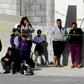 A police officer (L) and neighbors watch a house where five people were killed in Mexico's Ciudad Juarez on January 16, 2019 -- the country suffered a record 33,341 homicides in 2018