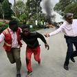 Survivors flee the scene of the attack on an upmarket hotel in the Kenyan capital